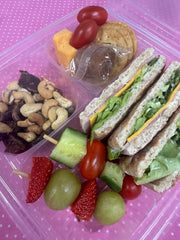 Wholewheat lunchbox with nuts, fruit and charcuterie