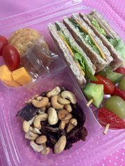 Wholewheat lunchbox with nuts, fruit and charcuterie